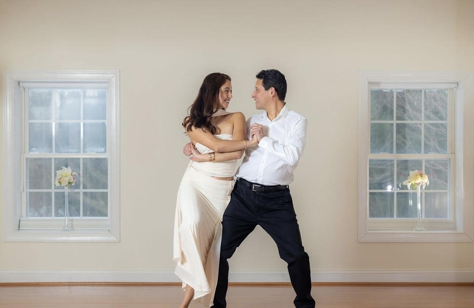Couple dancing together in a bright studio